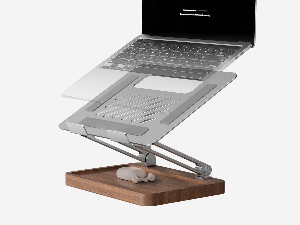 Adjustable walnut and aluminum laptop stand on a desk