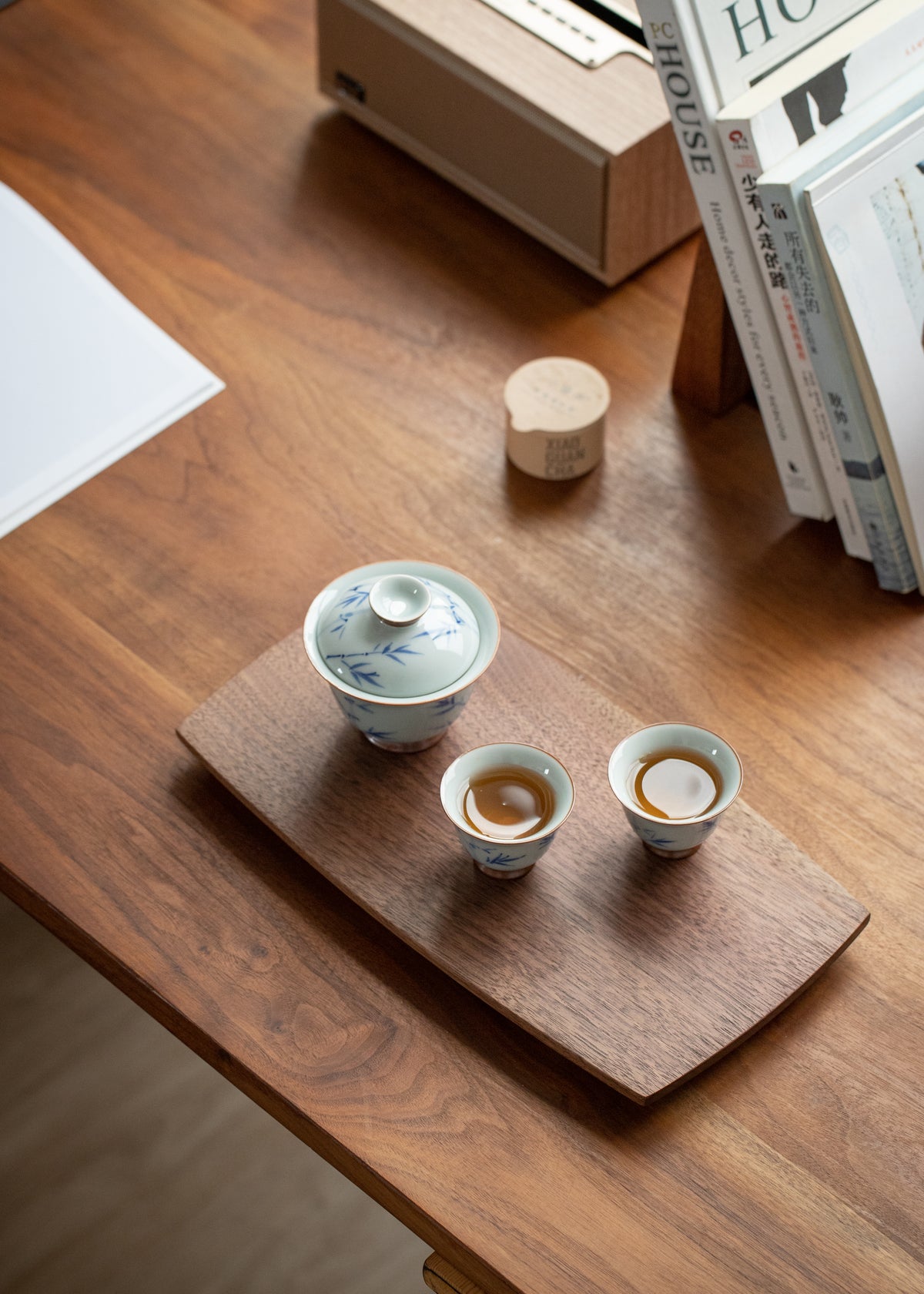 30 cm walnut curved-edge tray with a lidded tea bowl and two teacups on a wooden desk