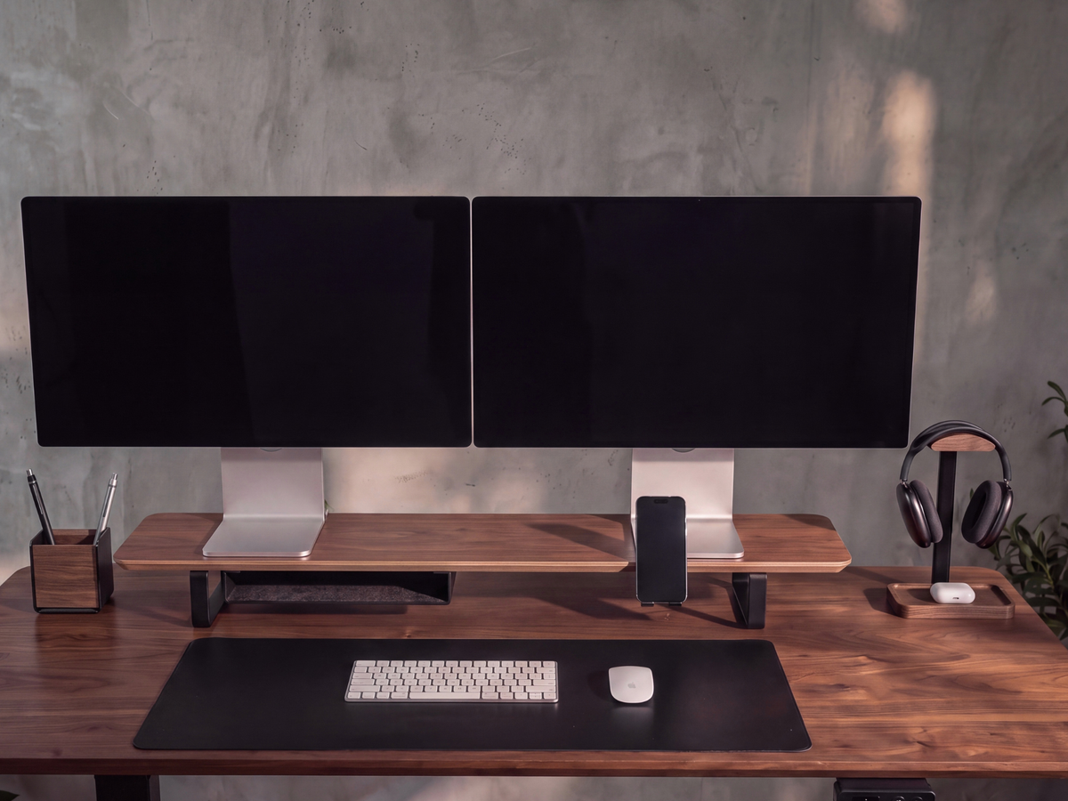 Two monitors on the Musowood walnut-veneer desk shelf with a storage tray and phone holder