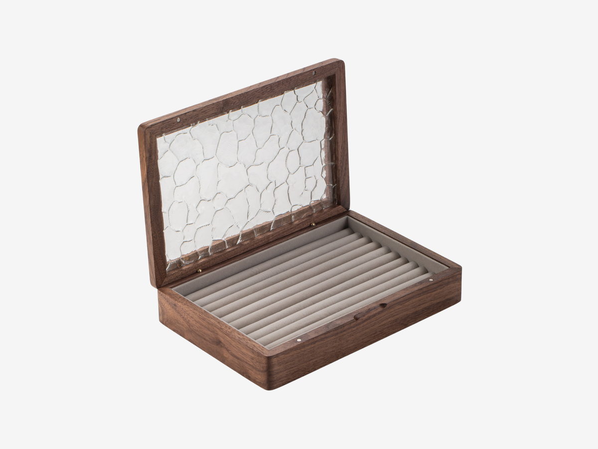 Open walnut ring and earring box with a rippled glass lid and lined jewelry slots