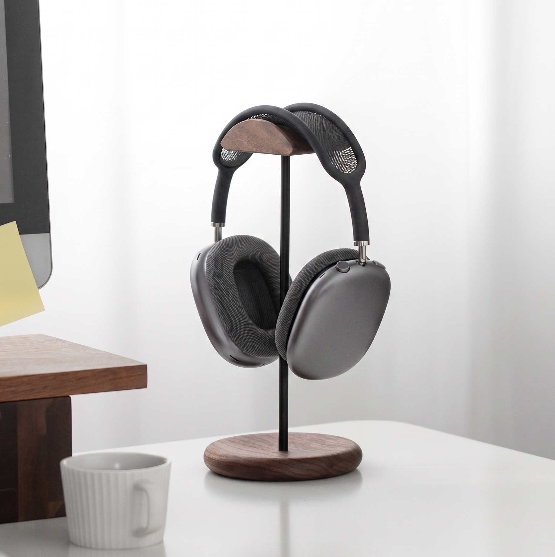 AirPods Max space gray resting on a solid walnut wood headphone stand, minimalist desk setup aesthetic - Musowood
